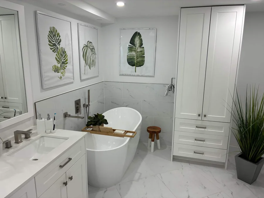 Bright bathroom with a freestanding tub and white cabinetry